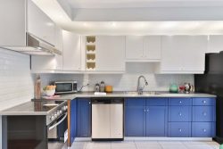 a modern kitchen with blue and white units