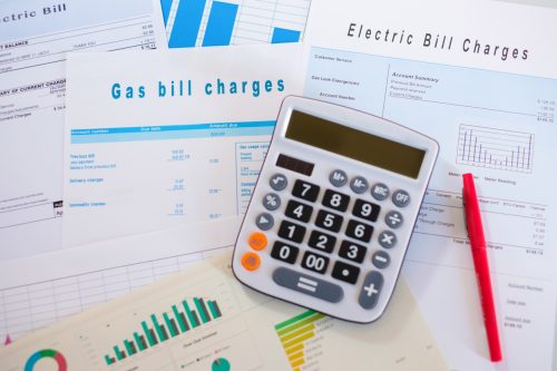 paperwork for energy bills and a calculator