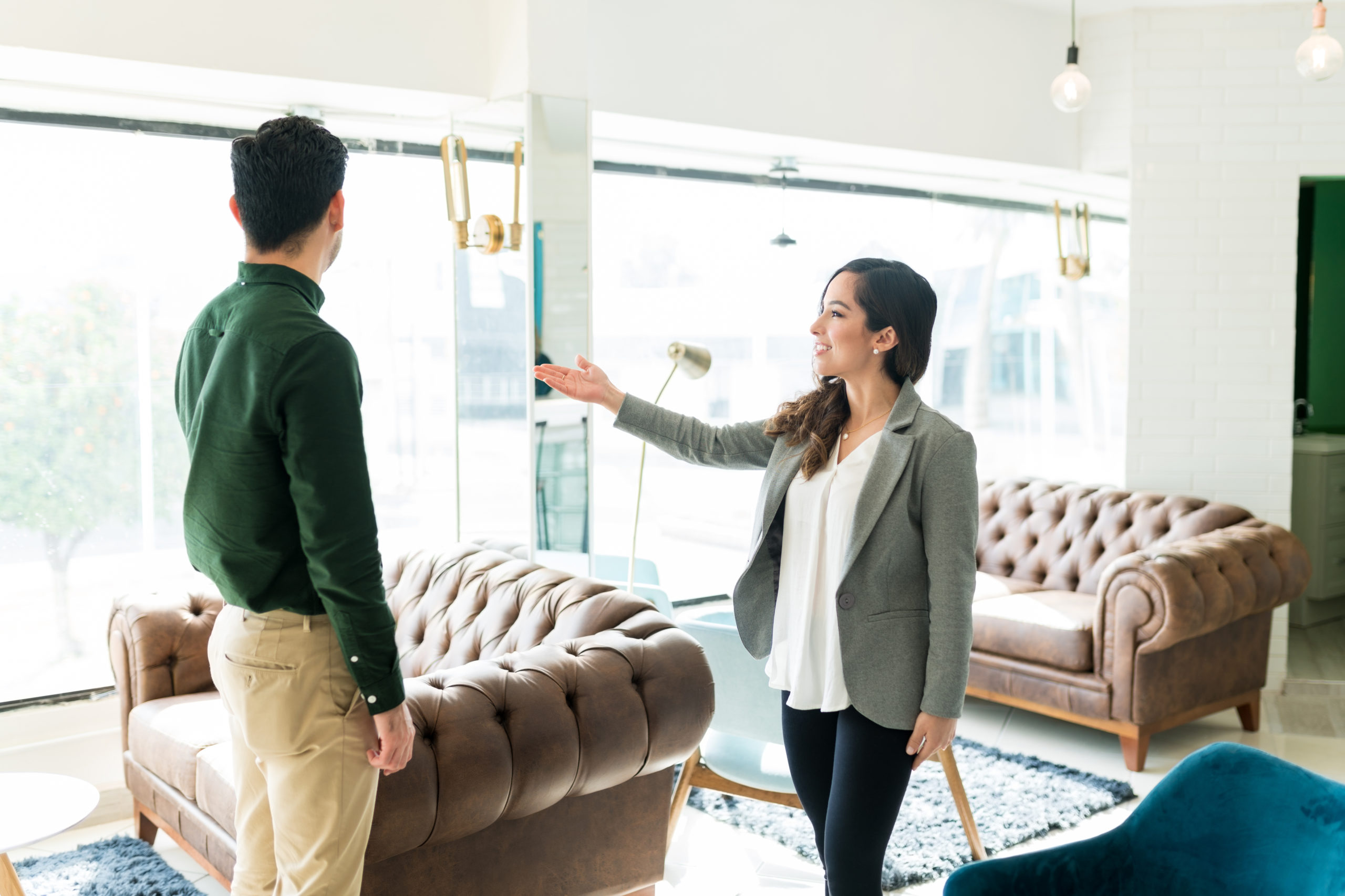 a woman showing a man a house